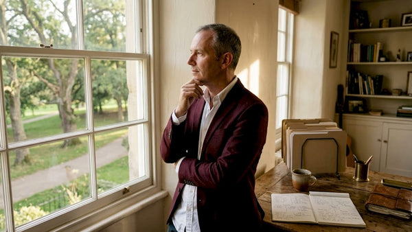 Business leader gazing out office window