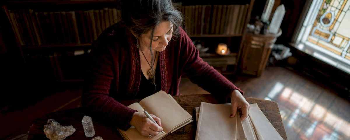 Spiritual practitioner reviewing client history for rituals