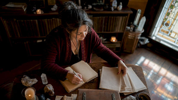 Spiritual practitioner reviewing client history for rituals