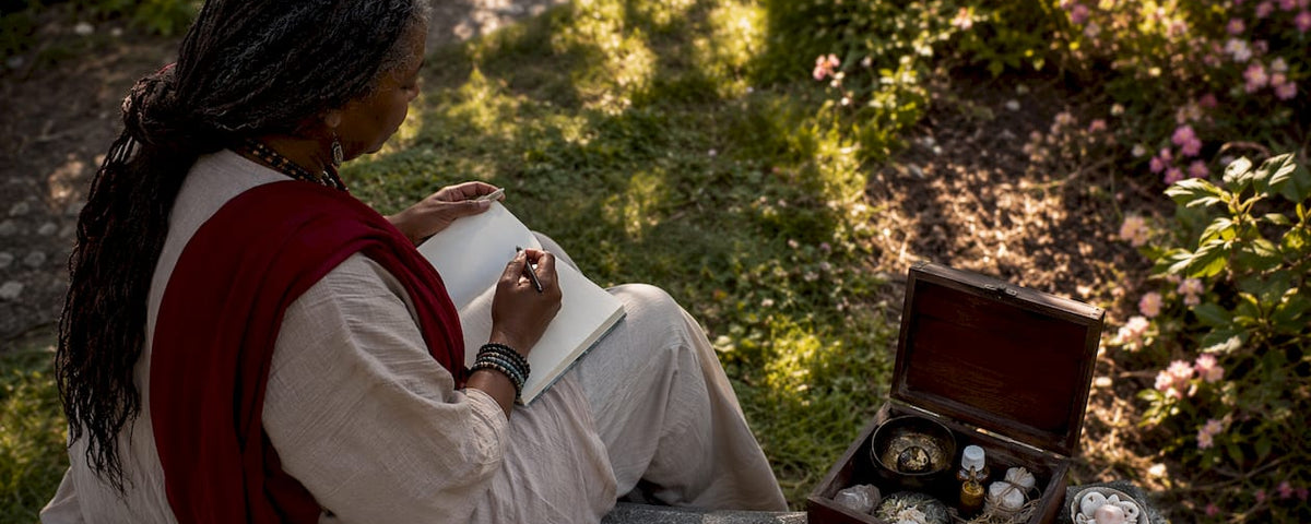 Woman journaling during reconciliation ritual outdoors