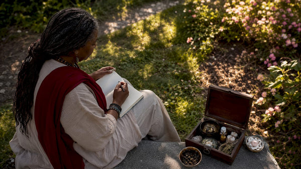 Woman journaling during reconciliation ritual outdoors