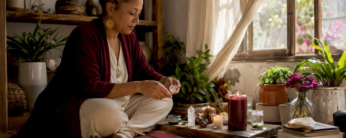 Businesswoman arranging spiritual altar at desk