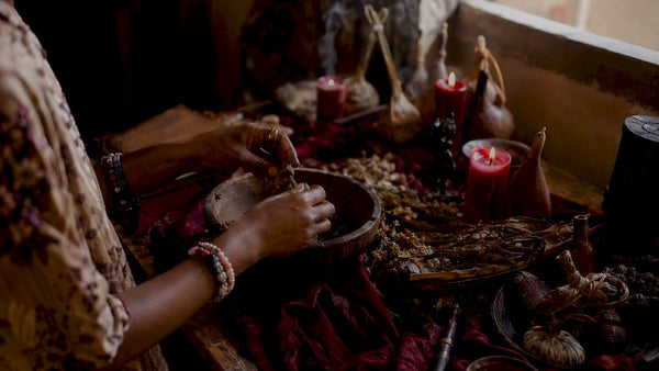 Hands performing West African love spell ritual