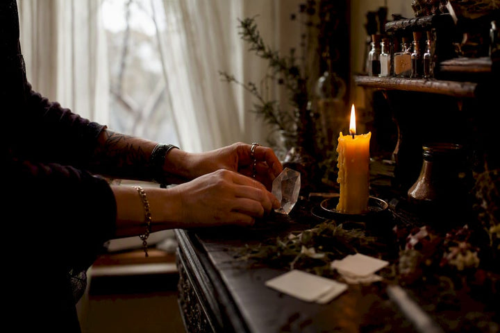 Hands lighting candle for communication spell