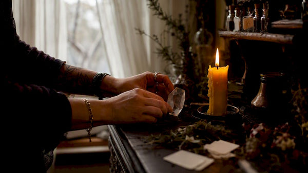Hands lighting candle for communication spell