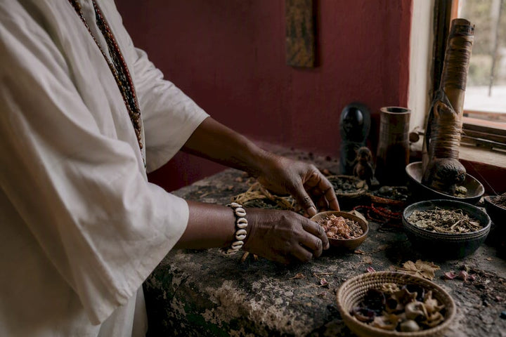 Hands placing ritual objects in ancestral healing