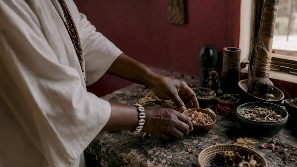 Hands placing ritual objects in ancestral healing