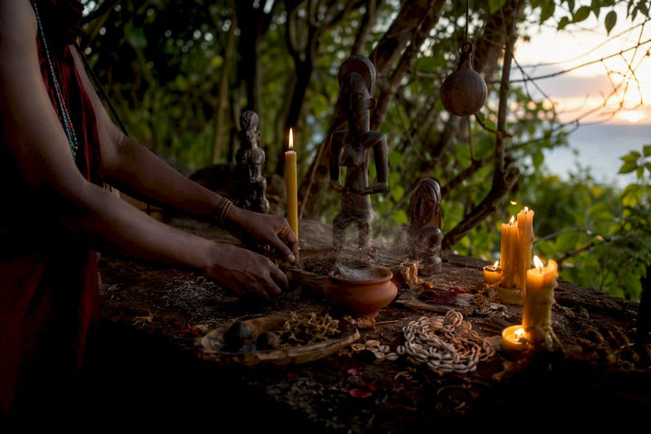 Hands arranging West African ritual objects