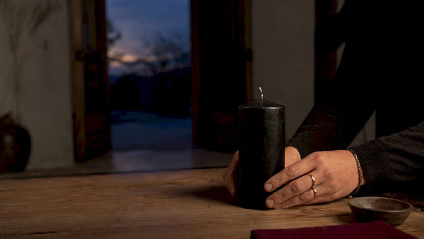 Black candle prepared for banishing ritual