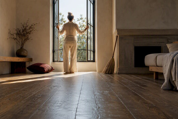 Person opening window in clean home